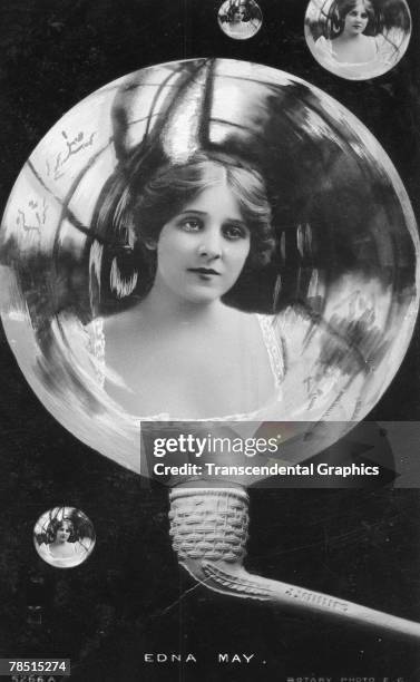 Retouched portrait of American actress and singer Edna May , with flowers in her hair and pictured as though she were in a bubble, emerging from a...