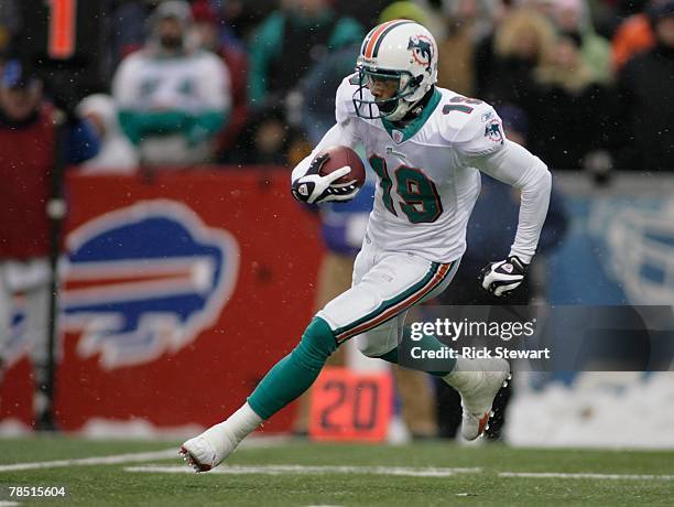 Ted Ginn Jr. #19 of the Miami Dolphins runs with the ball gainst the Buffalo Bills on December 9, 2007 at Ralph Wilson Stadium in Orchard Park, New...