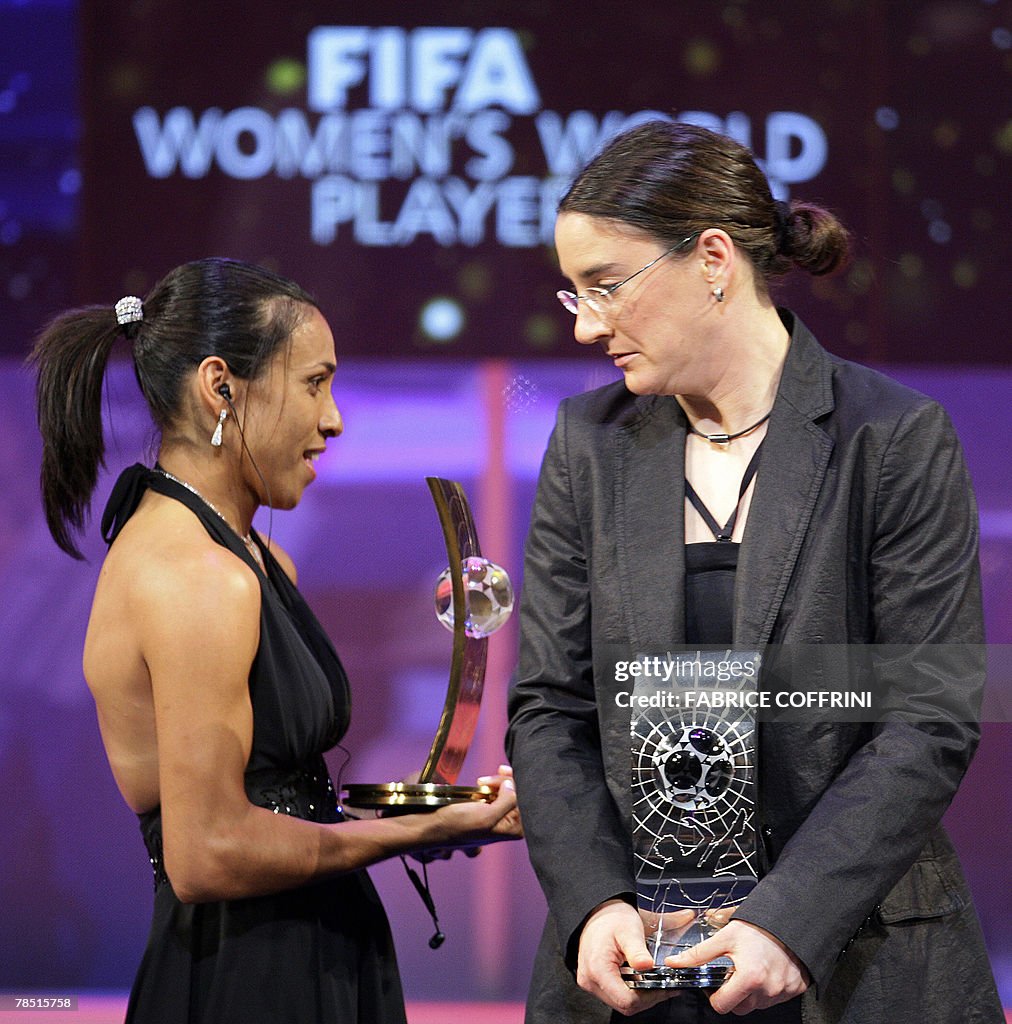 Brazil's football player Marta (L) holdi