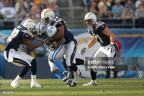 Stephen Cooper and Clinton Hart of the San Diego Chargers tackle Kevin Jones of the Detroit Lions on December 16, 2007 at Qualcomm Stadium in San...