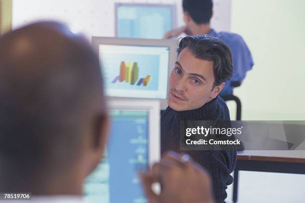 men using computers at work - computer screen over shoulder office stock pictures, royalty-free photos & images