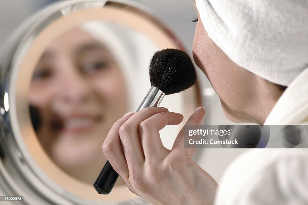 Woman applying blush