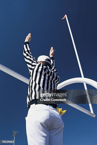 football referee signaling touchdown - palo della porta foto e immagini stock
