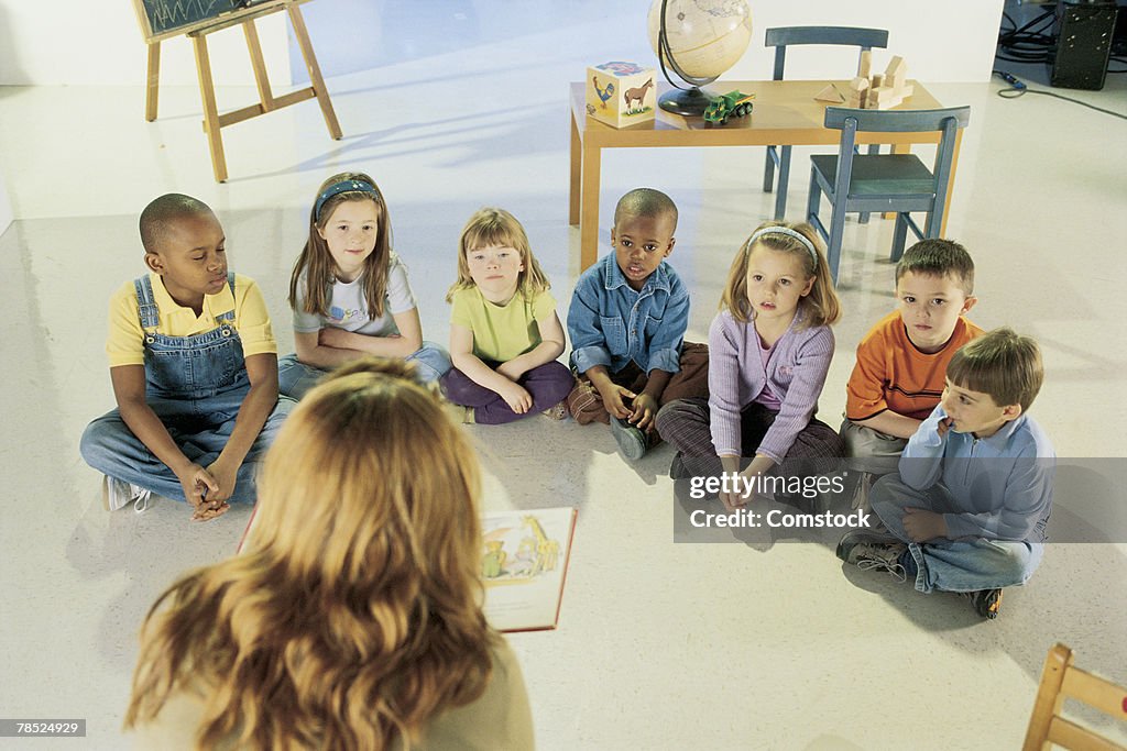 Children listening to teacher at story time