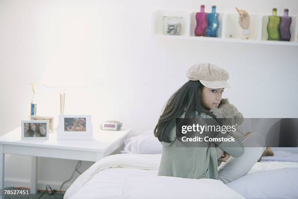 teenage girl holding teddy bear - kuscheldecke stock-fotos und bilder