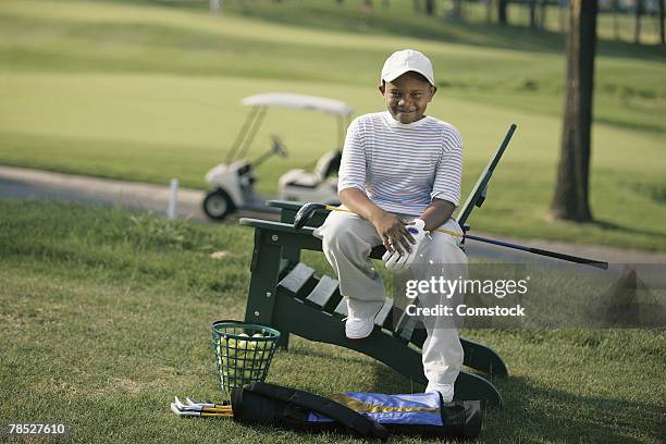 boy on golf course - young golfer stock pictures, royalty-free photos & images