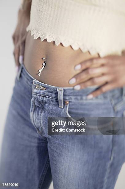 close-up of woman with belly ring - belly ring fotografías e imágenes de stock