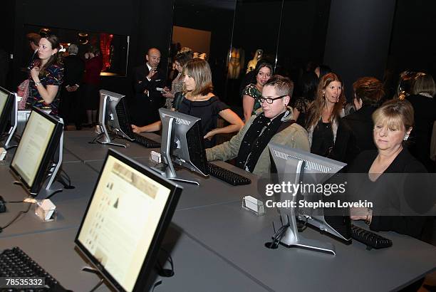 People look at computers at the "Blog.mode Addressing Fashion" reception at The Metropolitan Museum of Art on December 17, 2007 in New York City.
