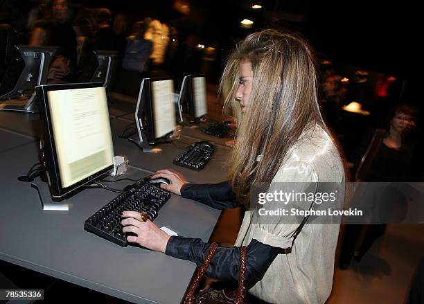 People look at computers at the "Blog.mode Addressing Fashion" reception at The Metropolitan Museum of Art on December 17, 2007 in New York City.