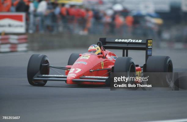 Italian racing driver Michele Alboreto , drives the Scuderia Ferrari SpA SEFAC Ferrari F1/87 Ferrari 033D 1.5 V6t in the 1987 British Grand Prix at...