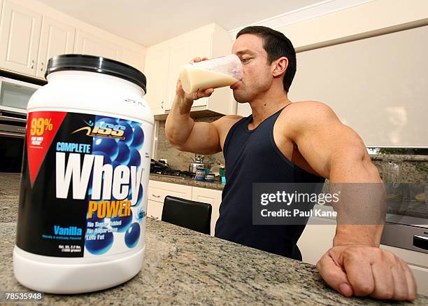 Australia's shortest competitive male bodybuilder, David Clarke, takes a protein supplement drink to help him gain mass at home in Karrinyup on...