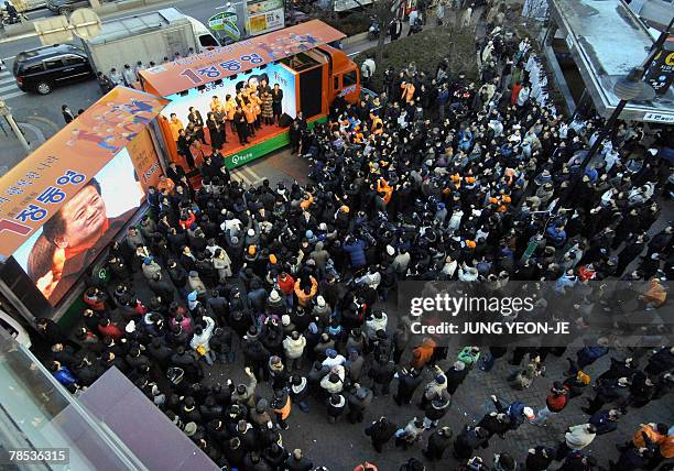 Supporters crowd around as Chung Dong-Young , South Korean presidential candidate for the pro-government United New Democratic Party, speaks during a...