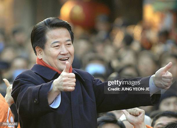 Chung Dong-Young, South Korean presidential candidate for the pro-government United New Democratic Party, gives supporters and the media a thumbs up...