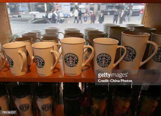 Shelf of Starbucks mugs in a store on December 18, 2007 in Chongqing, China. Starbucks has issued a recall of 167,000 'Fusion' mugs on December 6....
