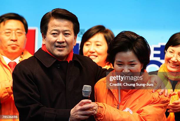 Presidential candidate Chung Dong-Young of the liberal United New Democratic Party stands next to Min Hae-Kyung as he takes to the downtown streets...