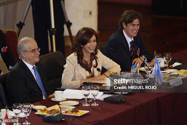 Argentina's president Cristina Fernandez de Kirchner smiles next to her Foreign minister Jorge Taiana and Economy minister Martin Lousteau before the...