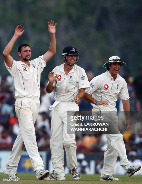 England bowler Stephen Harmison celebrates with teammates Alastair Cook and captain Michael Vaughan the dismissal of unseen Sri Lankan cricketer...