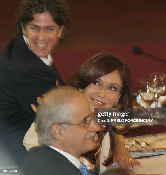 Argentina's president Cristina Fernandez de Kirchner smiles flanked by her Economy minister Martin Lousteau and Foreign minister Jorge Taiana before...