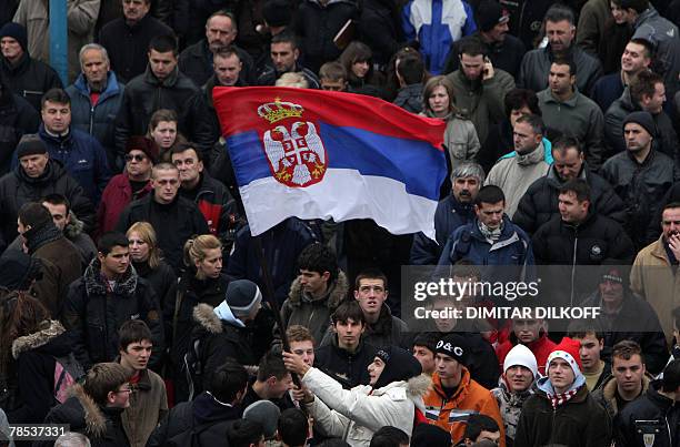 Serbs wave a Serbian national flag in the ethnically divided Kosovo town of Mitrovica, 18 December 2007, during a rally against EU leaders plan to...