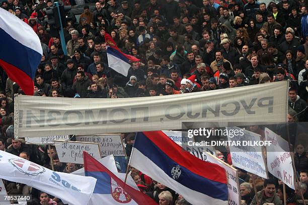 Serbs wave a Serbian national flags in the ethnically divided Kosovo town of Mitrovica, 18 December 2007, during a rally against EU leaders plan to...