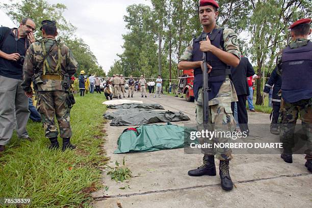 Soldiers stand by the remains of those who lost their lives when a jet crashed after running out of fuel in Limpio, Paraguay, 20 km from Asuncion, 18...