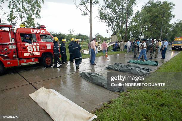 Rescue workers surround the remains of those who lost their lives when a jet crashed after running out of fuel in Limpio, Paraguay, 20 km from...