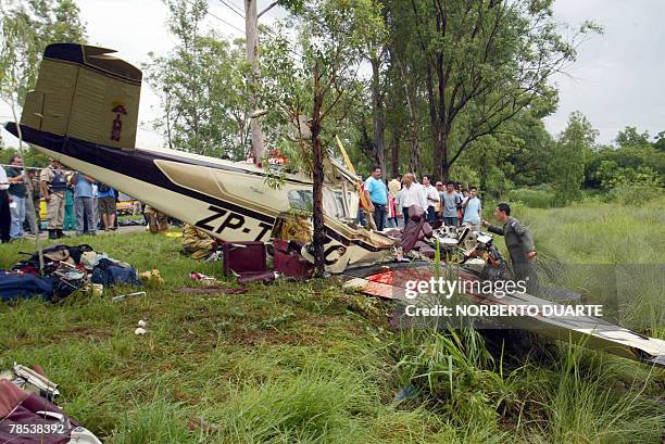 Rescue workers examine the debris of a jet that crashed after running out of fuel in Limpio, Paraguay, 20 km from Asuncion, 18 December, 2007. The...