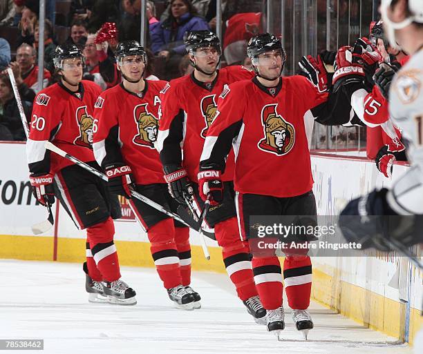 Randy Robitaille of the Ottawa Senators celebrates his goal against the Nashville Predators at the bench with team-mates Chris Phillips, Wade Redden,...