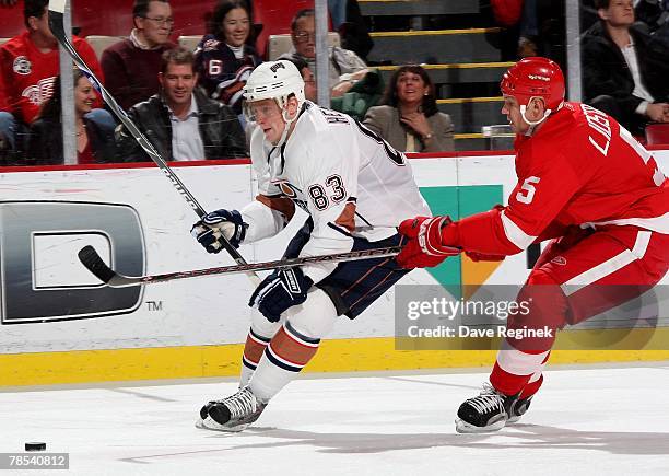 Alex Hemsky of the Edmonton Oilers tries to skate by the defence of Nick Lidstrom of the Detroit Red Wings during an NHL game on December 13, 2007 at...