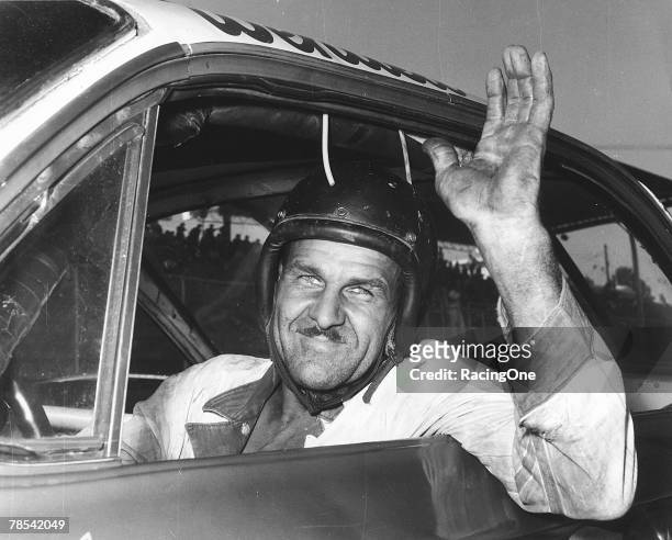Racer Wendell Scott waves from his car, Jacksonville, Florida, December 1, 1963. On this day, he won the 200-mile event at Jacksonville Speedway, his...