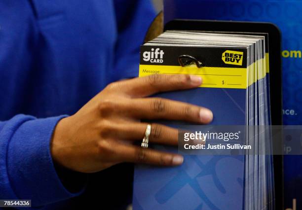 Best Buy employee pulls a gift card from a display rack December 18, 2007 in San Francisco, California. Consumer electronics retail giant Best Buy...