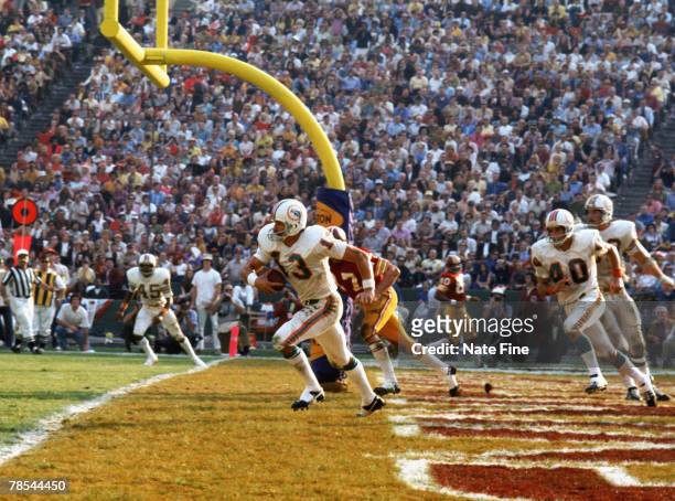 Miami Dolphins safety Jake Scott intercepts a fourth quarter pass in his end zone and returns it 55 yards against the Washington Redskins in Super...