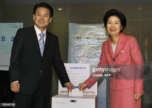 South Korea's United New Democratic Party presidential candidate Chung Dong-Young and his wife Min Hye-Keong pose for the media as they cast their...
