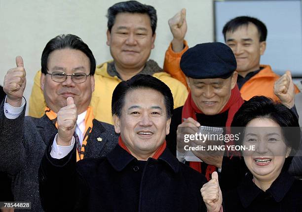 South Korea's United New Democratic Party presidential candidate Chung Dong-Young and his wife Min Hae-Kyung give a thumbs up for photographers after...