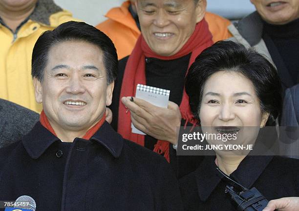 South Korea's United New Democratic Party presidential candidate Chung Dong-Young and his wife Min Hae-Kyung smile after casting their ballots in the...