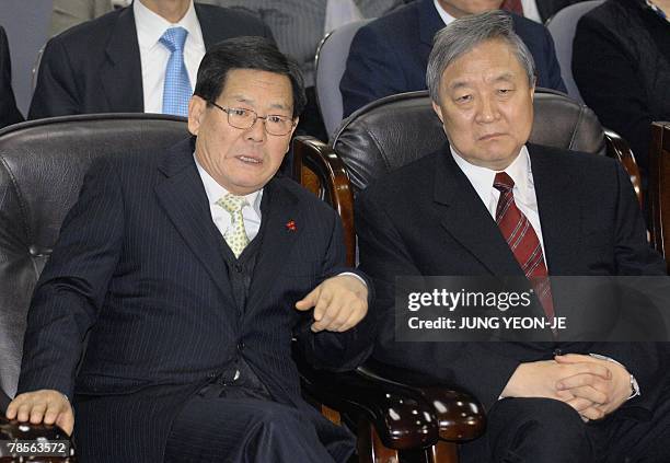 Oh Choong-Il , chairman of the pro-government United New Democratic Party , and a party member silently watch national television broadcast the...