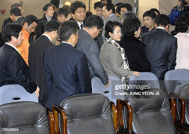 Members of the pro-government United New Democratic Party get up and leave the party's headquarters after watching national television broadcasts of...