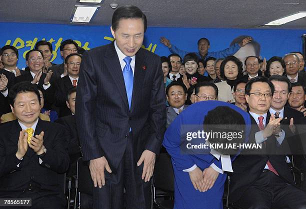 South Korea's Grand National Party presidential candidate Lee Myung-Bak and his wife Kim Yun-Ok bow to thank supporters and party members at party...