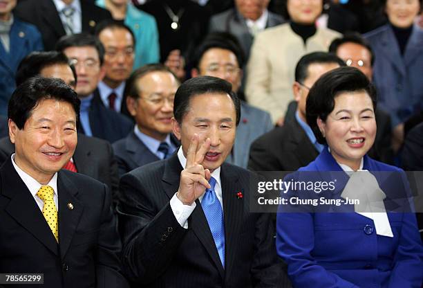 Lee Myung-Bak of the conservative main opposition Grand National Party , celebrates with a vistory sign, beside his wife Kim Yoon-Ok, after he is...