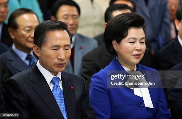 Lee Myung-Bak of the conservative main opposition Grand National Party and his wife Kim Yoon-Ok await with party members for the results of the...