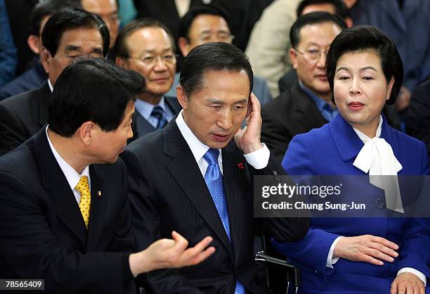 Lee Myung-Bak of the conservative main opposition Grand National Party and his wife Kim Yoon-Ok listens with party members for the results of the...