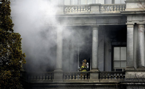 Firefighter walks through the smoke as he fights a fire at the Eisenhower Executive Office Building next the White House in Washington, DC, 19...