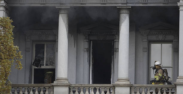 Firefighter approaches the smoke as he fights a fire at the Eisenhower Executive Office Building next to the White House in Washington, DC, 19...