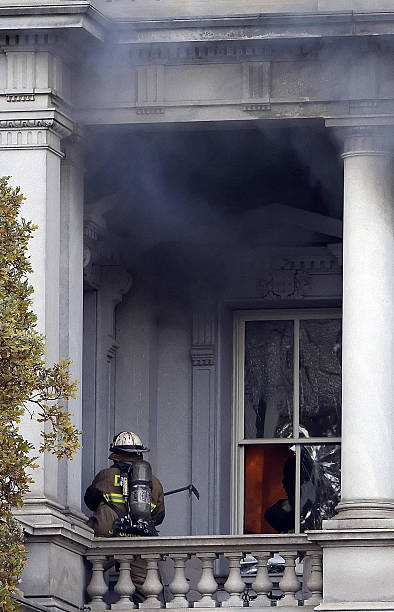 Firefighter walks through the smoke as he fights a fire at the Eisenhower Executive Office Building next to the White House in Washington, DC, 19...