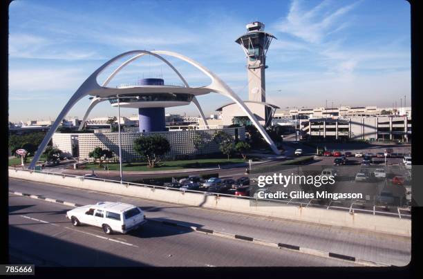 Station wagon drives past the Theme Building at Los Angeles International Airport December 15, 1997 in Los Angeles, CA. A primary goal of the LAX...