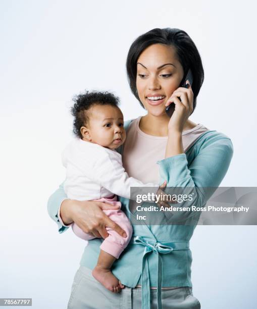 african american mother talking on cell phone - mother holding baby white background stock pictures, royalty-free photos & images