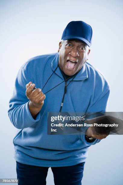 african american man holding stopwatch - coaching stock-fotos und bilder