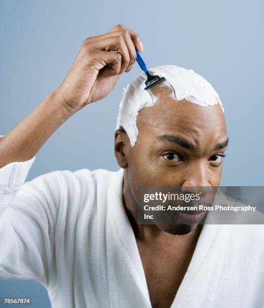 african american man shaving head - shaving head stock pictures, royalty-free photos & images