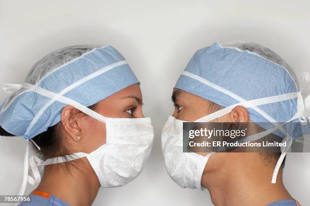 asian medical professionals wearing surgical masks - mask confrontation stock pictures, royalty-free photos & images