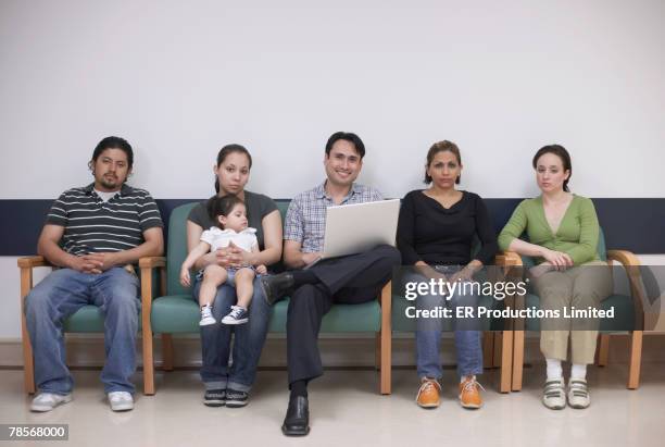 hispanic family sitting in waiting room - people family group sad stock pictures, royalty-free photos & images